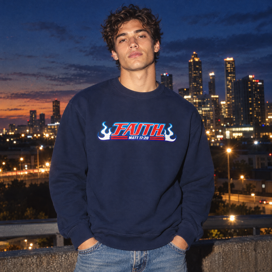 A man wearing a navy blue crewneck sweatshirt with a 'FAITH MATT 17:24' graphic on the chest, standing outdoors at dusk with a city skyline in the background.