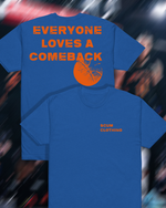 Blue t-shirt with 'Everyone Loves a Comeback' text and orange design on a blurred background