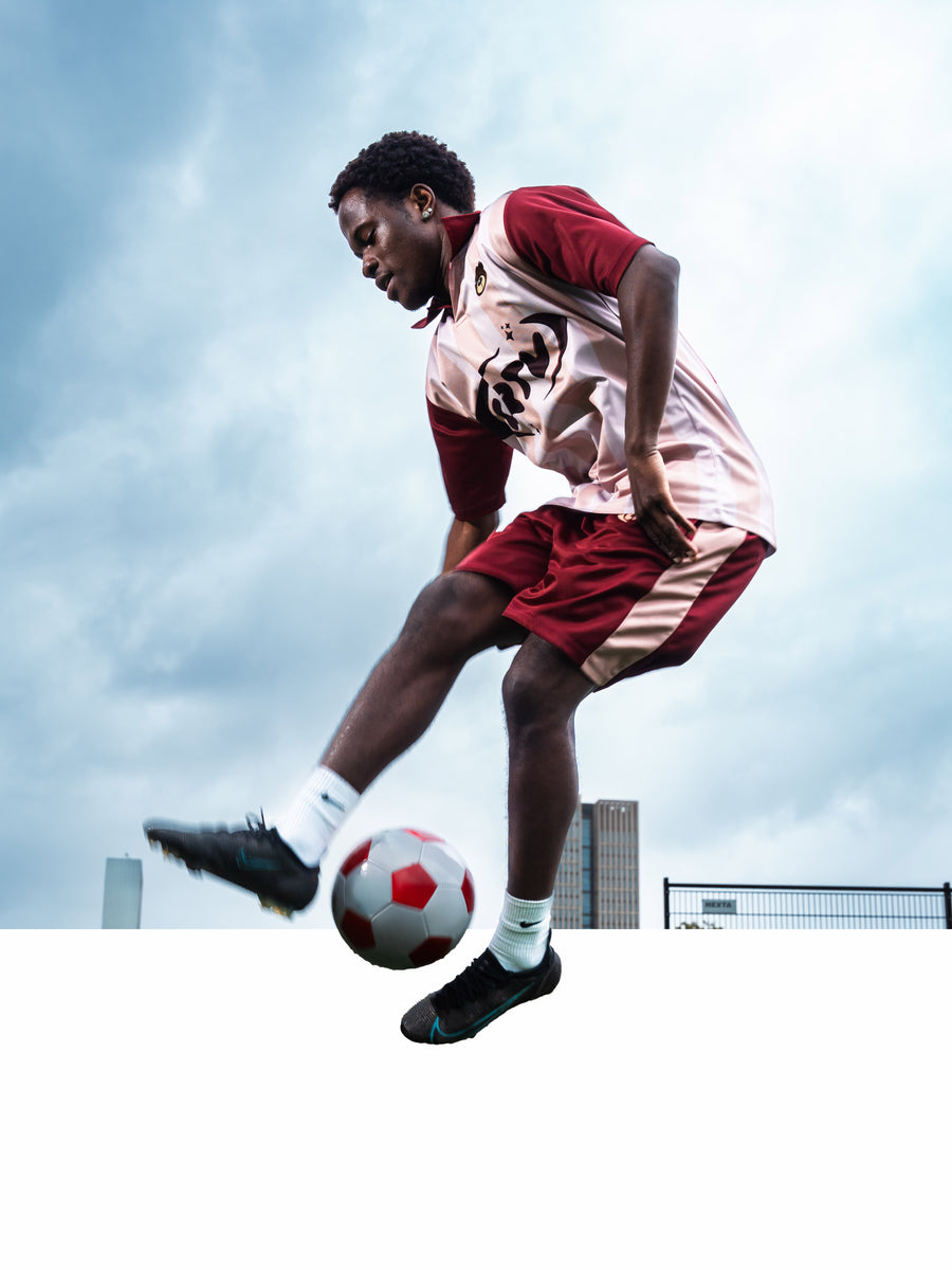 Person playing soccer with a clear sky background